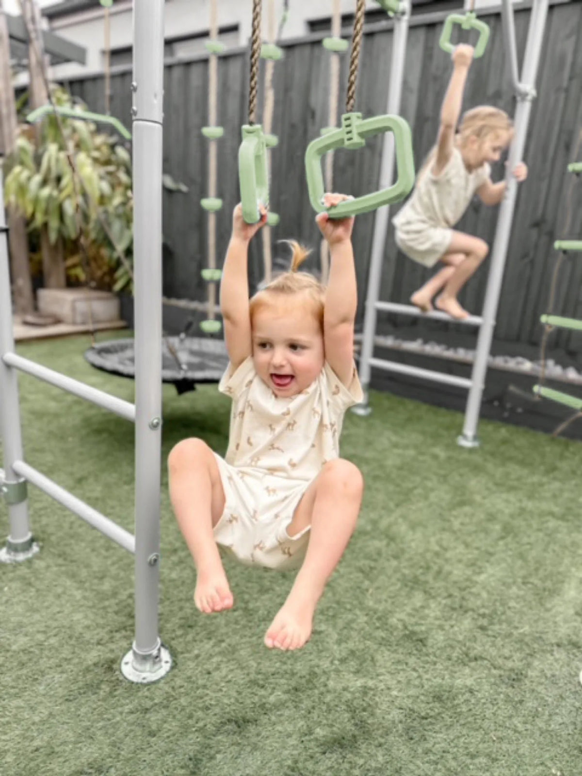 Gym Rings in use on a Growplay frame in a family garden