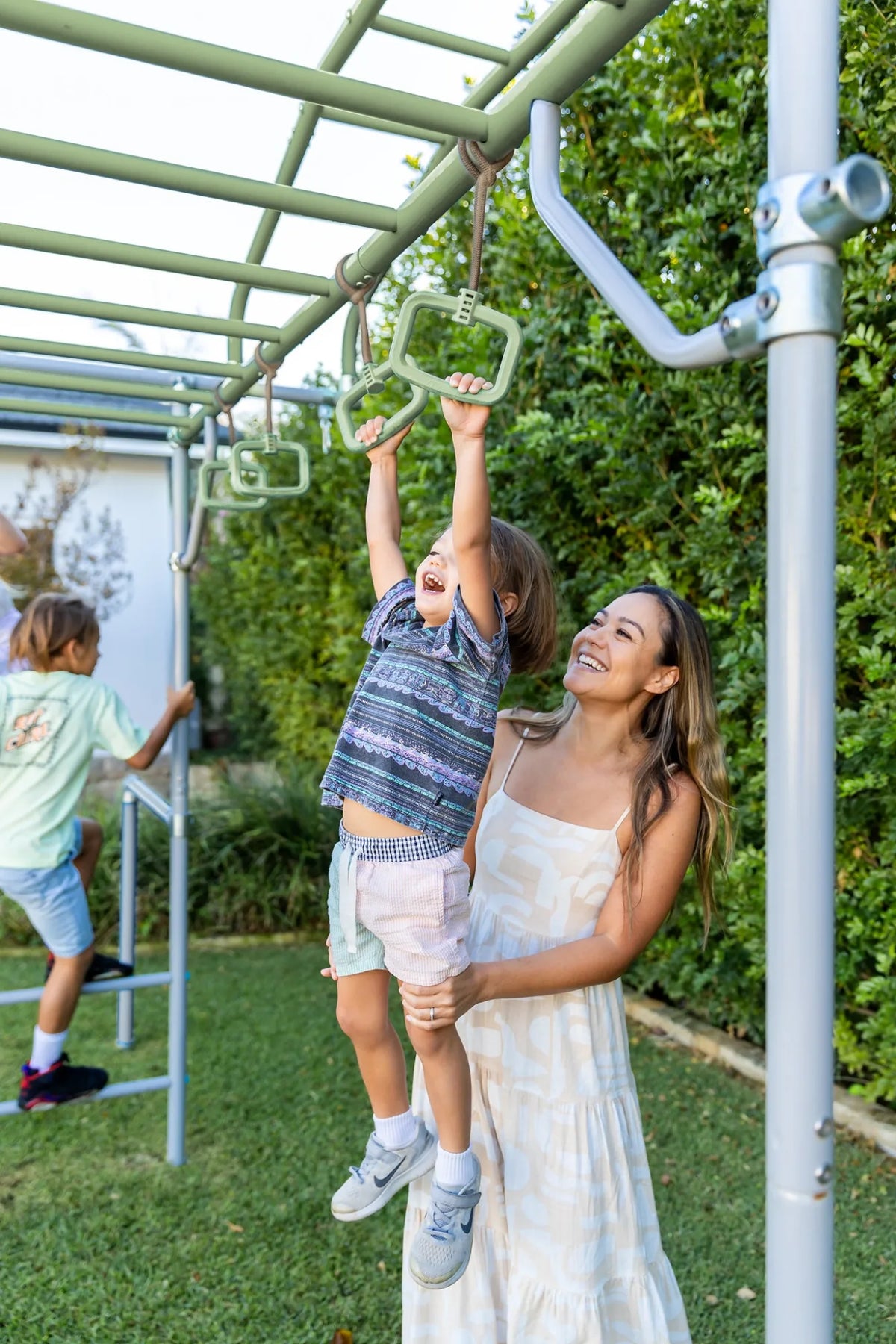 Monkey Rings in use on a Growplay frame in a family garden