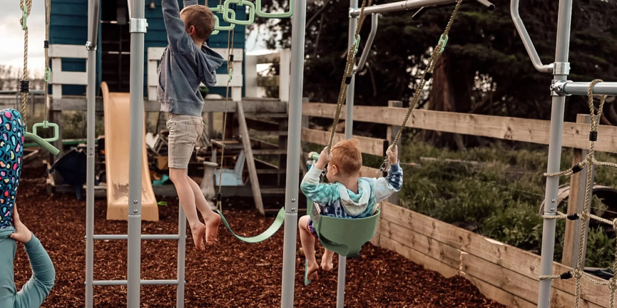 Toddler Swing in use on a Growplay frame in a family garden