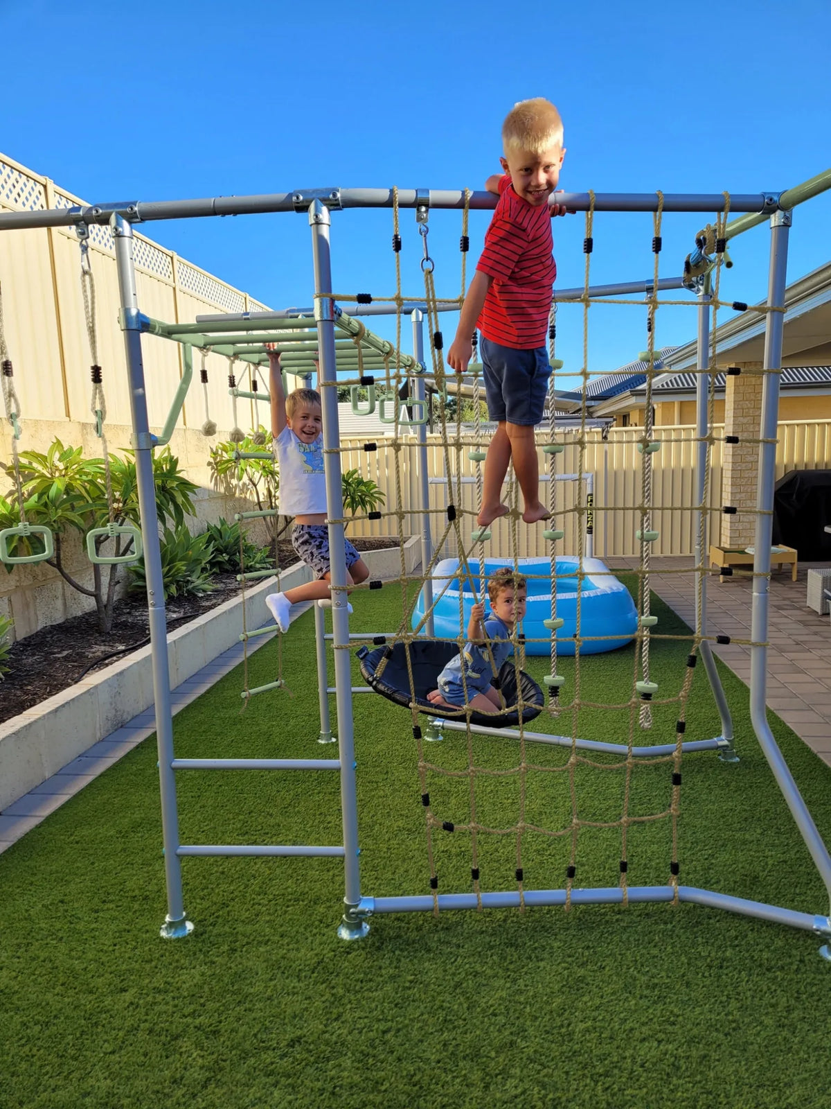 Cargo Net + Pole in use on a Growplay frame in a family garden
