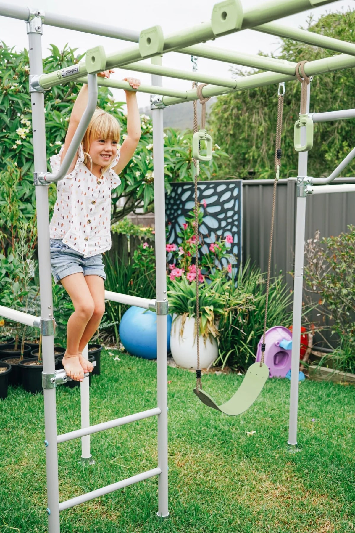 Adjustable Steps in use on a Growplay frame in a family garden
