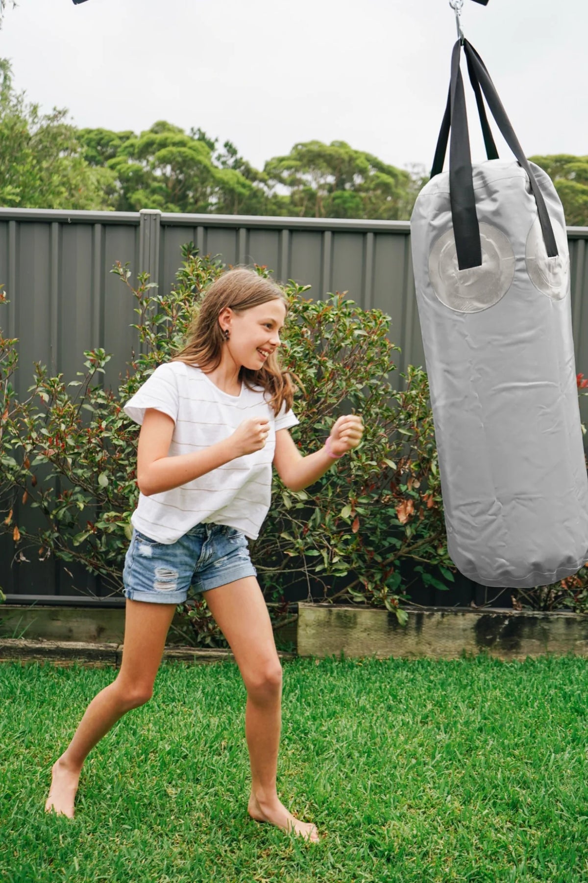 Boxing Bag in use on a Growplay frame in a family garden