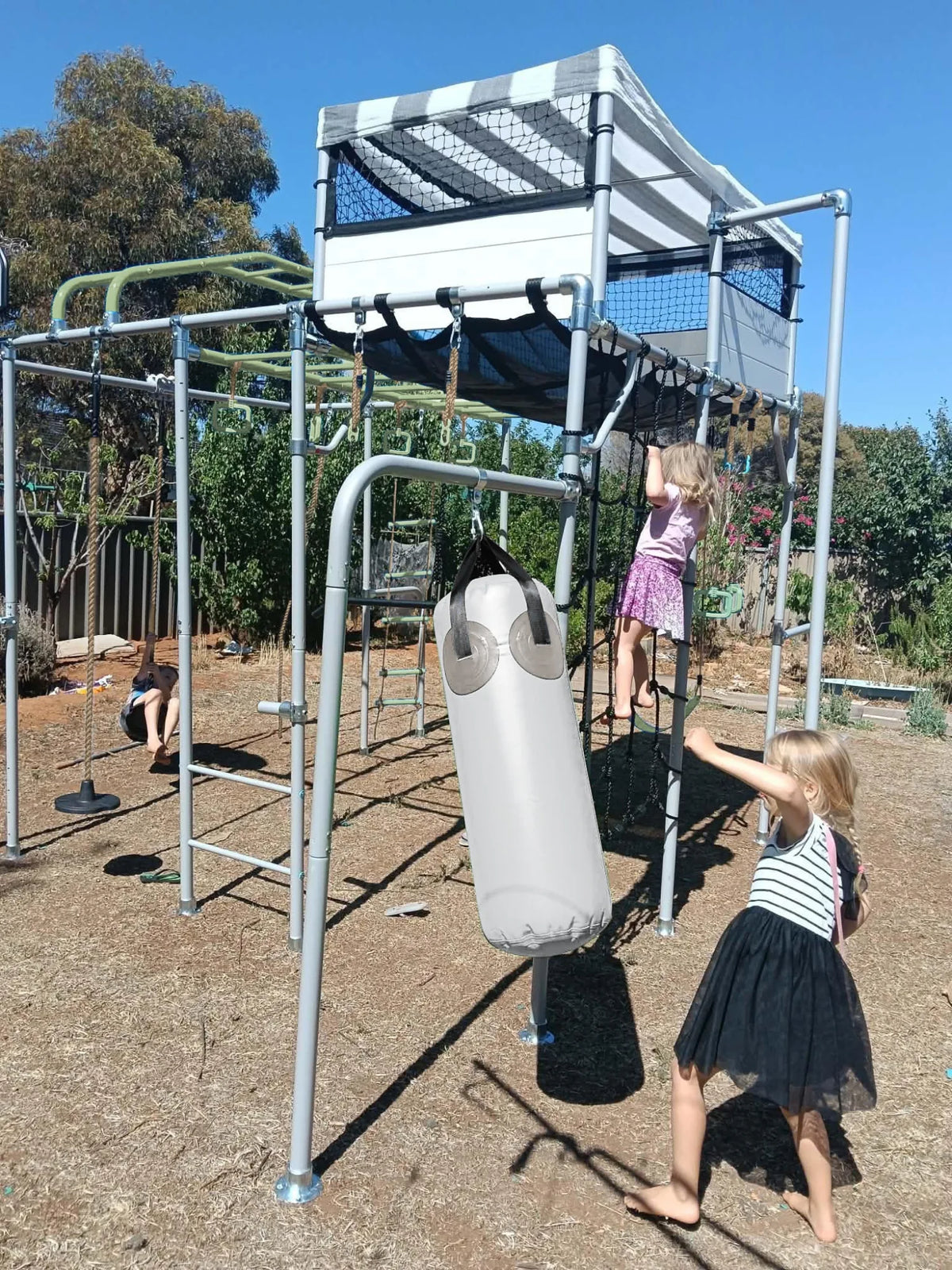 Boxing Bag in use on a Growplay frame in a family garden