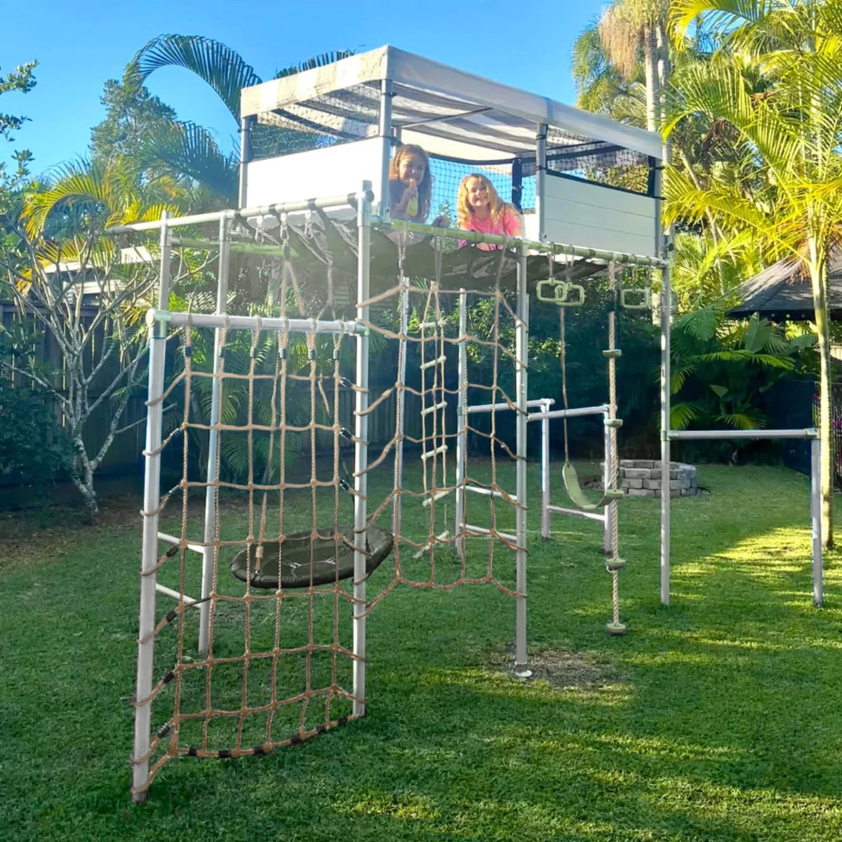 Playhouse in use on a Growplay frame in a family garden