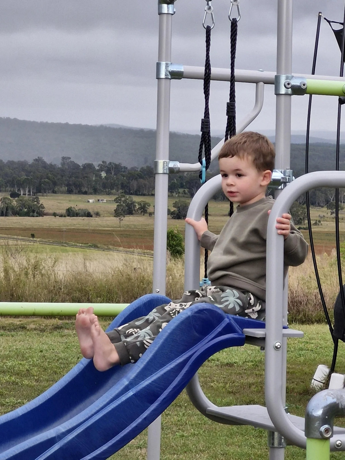 Slide Mount in use on a Growplay frame in a family garden