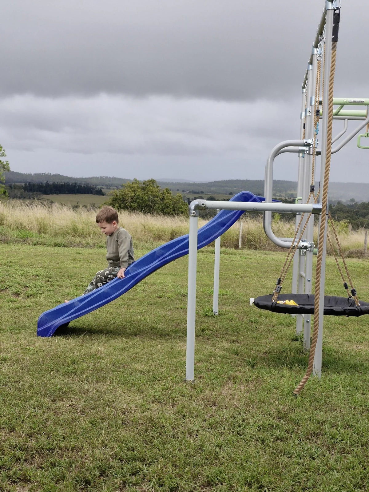 Slide Mount in use on a Growplay frame in a family garden