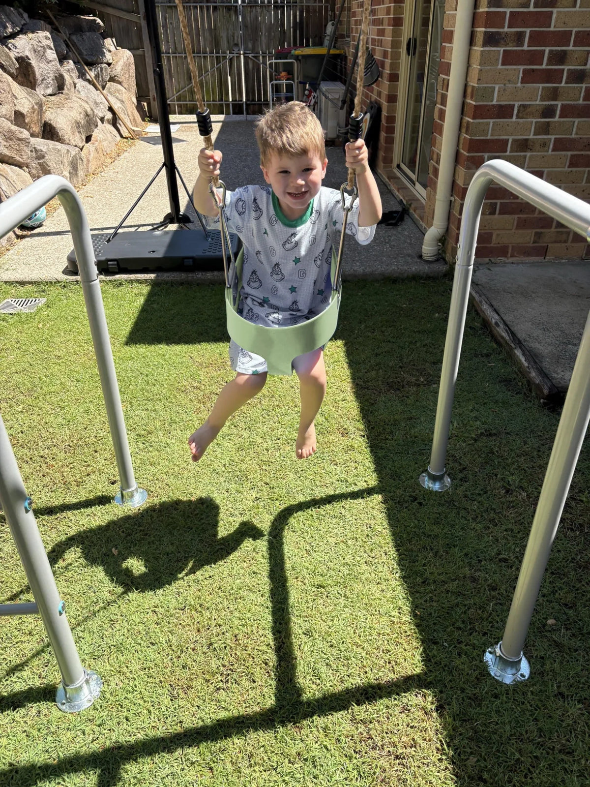 Toddler Swing in use on a Growplay frame in a family garden