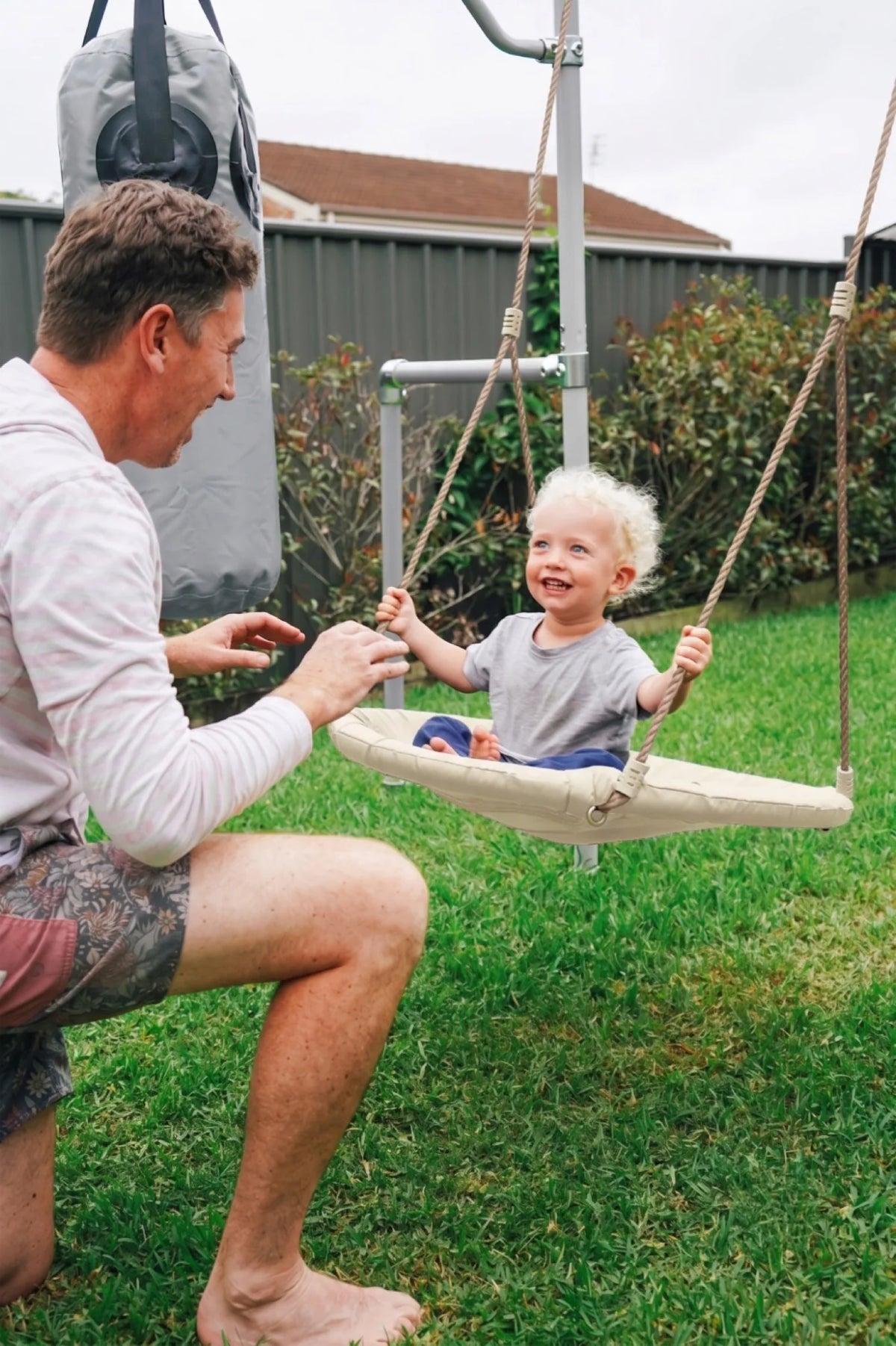 Net Swing in use on a Growplay frame in a family garden
