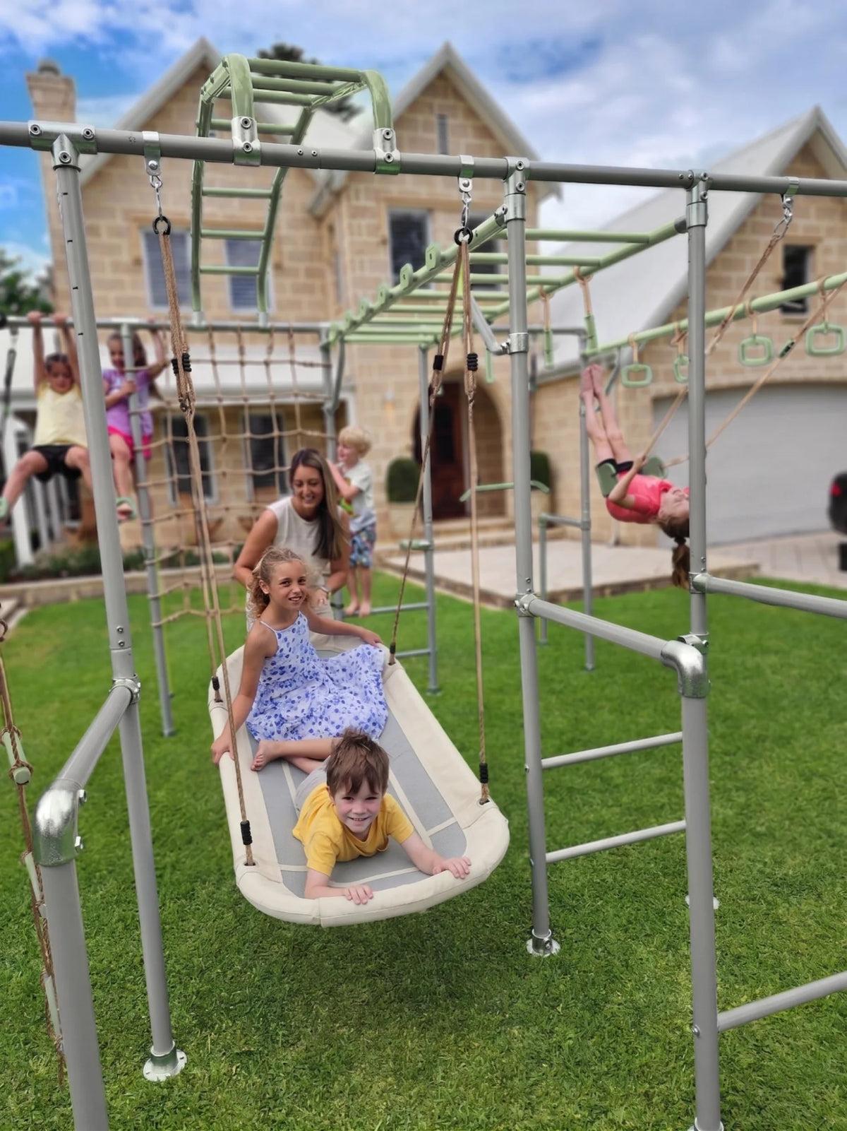 Boat Swing in use on a Growplay frame in a family garden